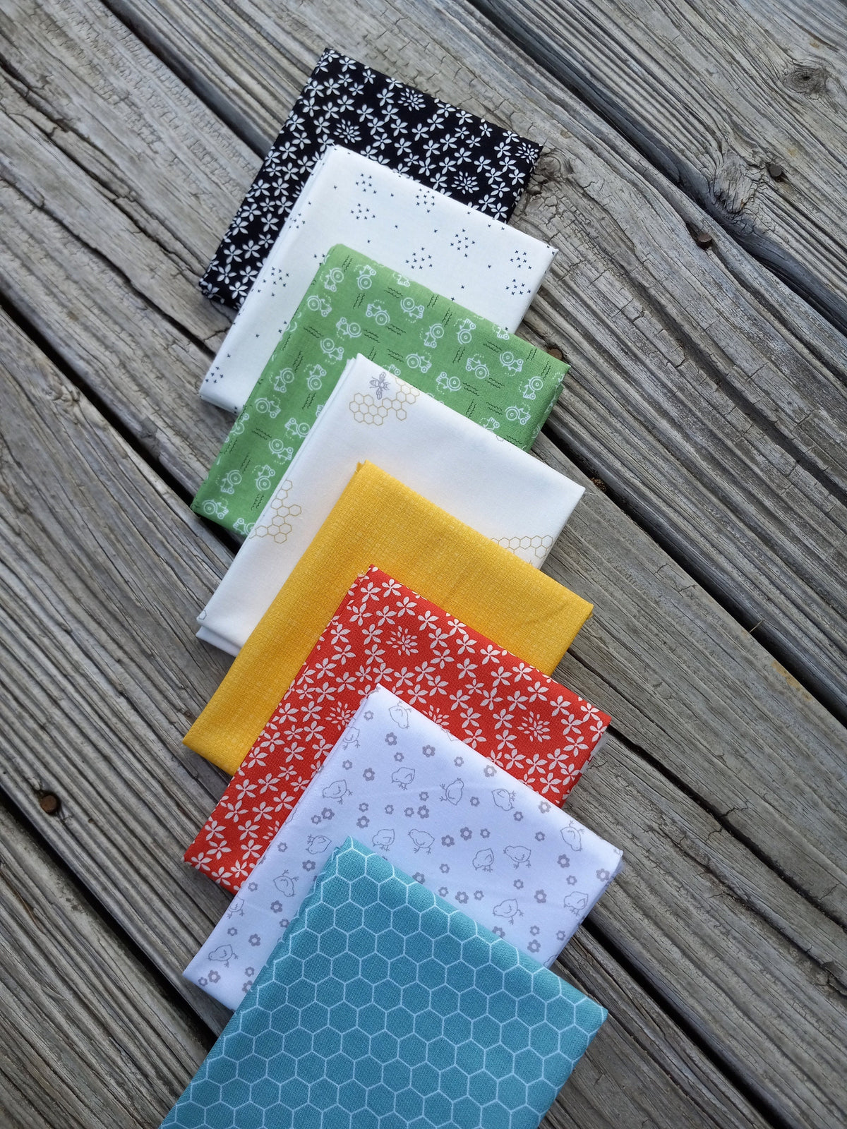 The Lil' Farm Fat Quarter Bundle ft. lil' tractors, chicks, honey bees, and chicken wire prints; 8 piece fabric bundle